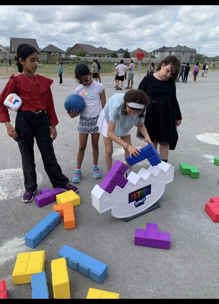 Children enjoying a colorful Tetris-style Xtreme Game setup